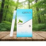 ซองบุหรี่ Oris Gum Mint และมวนบุหรี่ Super Slims บนโต๊ะไม้ท่ามกลางบรรยากาศป่าธรรมชาติ