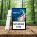 ซองบุหรี่ Mevius Option 2 สีน้ำเงินเข้มพร้อมสัญลักษณ์เม็ดบีบคู่สีม่วงและเขียว วางบนโต๊ะไม้ฉากหลังป่า