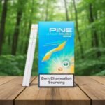 ซองบุหรี่ Pine Change Double Orange สีฟ้าสว่างวางบนโต๊ะไม้ฉากหลังป่าสีเขียว